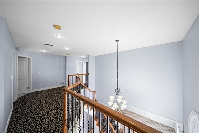 corridor with carpet and a chandelier