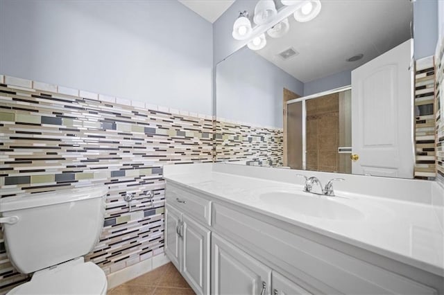 bathroom with walk in shower, vanity, tile patterned flooring, and toilet