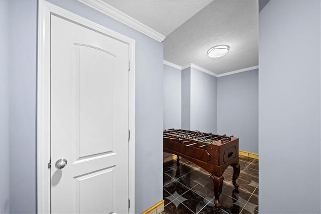 playroom featuring a textured ceiling and ornamental molding