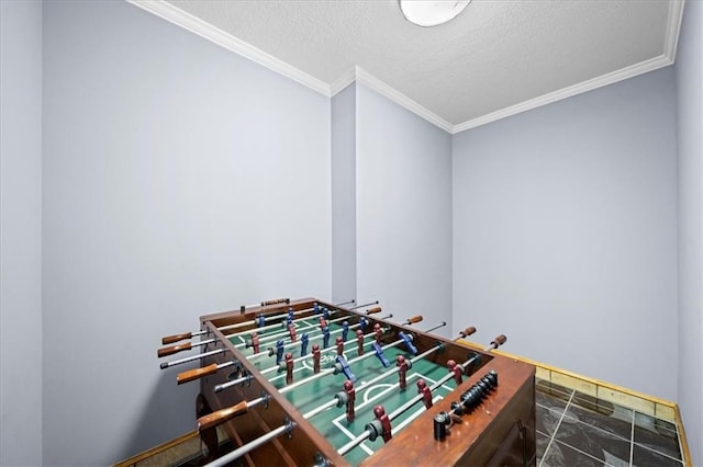 recreation room featuring a textured ceiling and crown molding