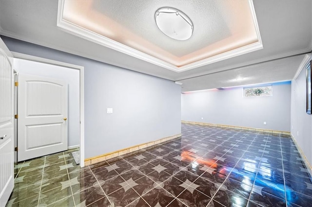 basement featuring a textured ceiling and ornamental molding