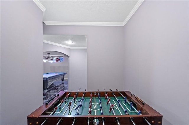 recreation room with billiards, ornamental molding, and a textured ceiling