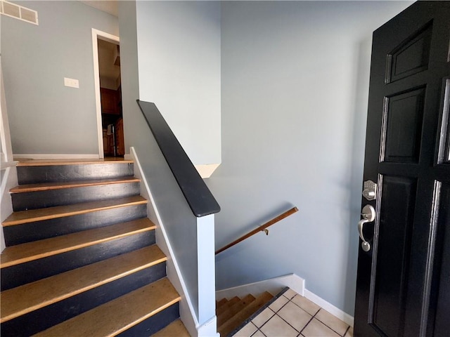 stairs featuring tile patterned floors