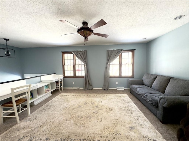 interior space featuring a textured ceiling and ceiling fan