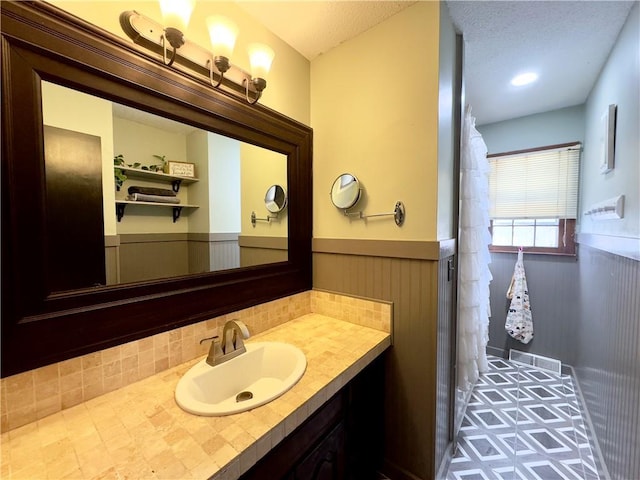 bathroom featuring vanity and a textured ceiling