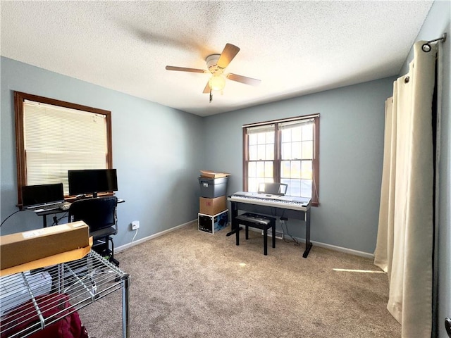 carpeted office space with ceiling fan and a textured ceiling