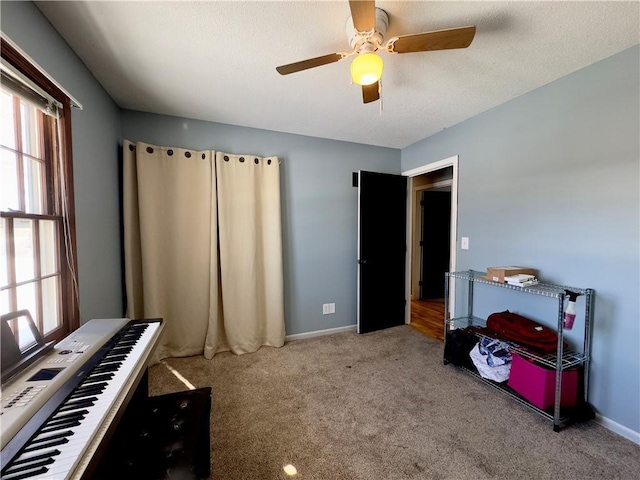 misc room with light carpet and ceiling fan