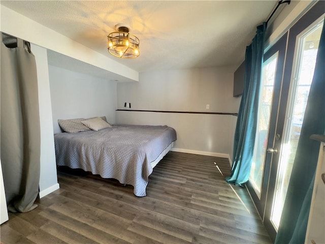 bedroom with dark hardwood / wood-style flooring