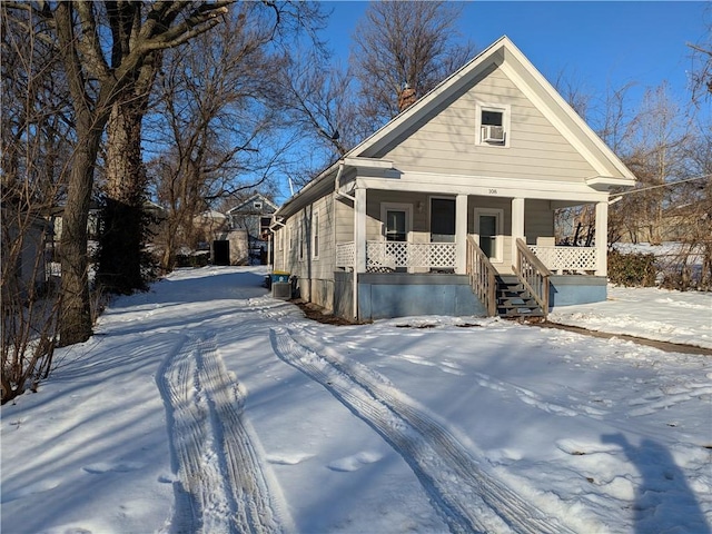 view of front facade featuring central AC unit, cooling unit, and covered porch