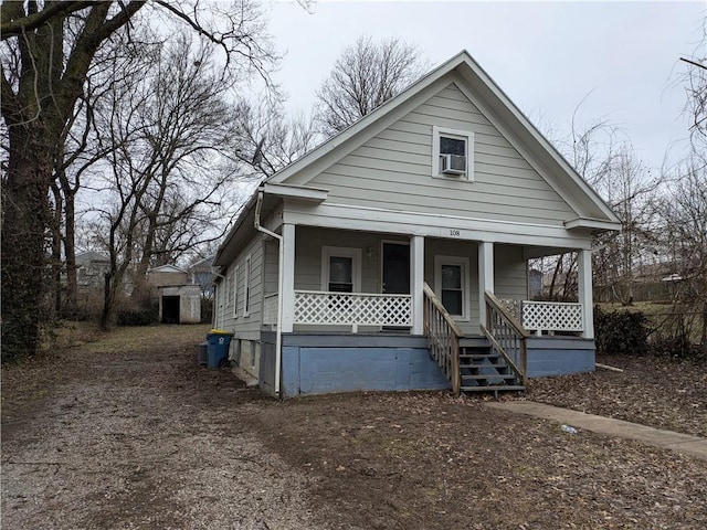 bungalow with cooling unit and a porch