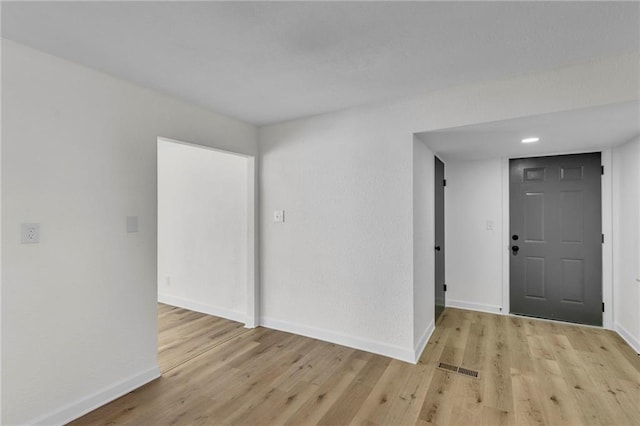 empty room with light hardwood / wood-style floors