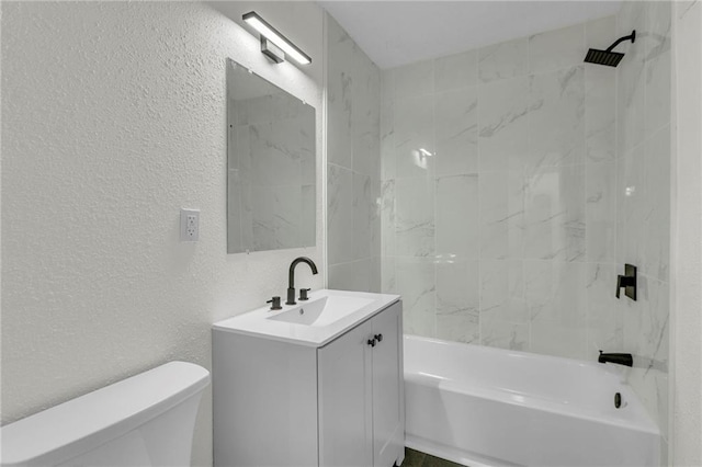 full bathroom with toilet, tiled shower / bath combo, and vanity