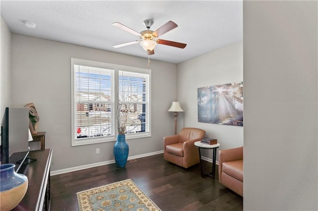 sitting room featuring ceiling fan and dark hardwood / wood-style flooring