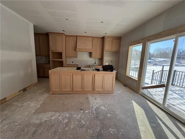 kitchen with a textured ceiling and a center island