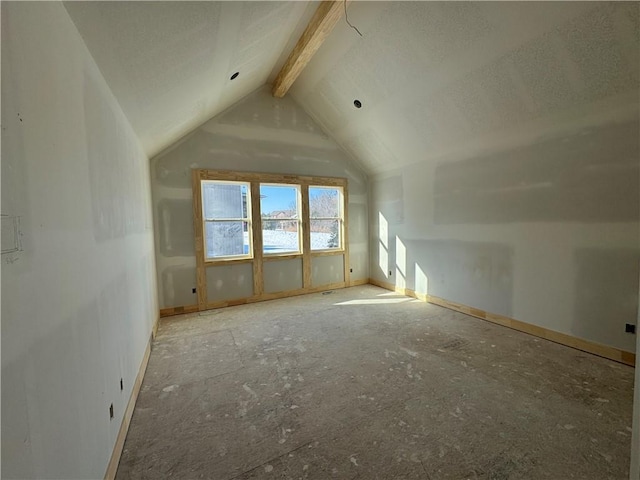 additional living space featuring vaulted ceiling with beams