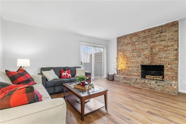 living room with wood-type flooring and a fireplace