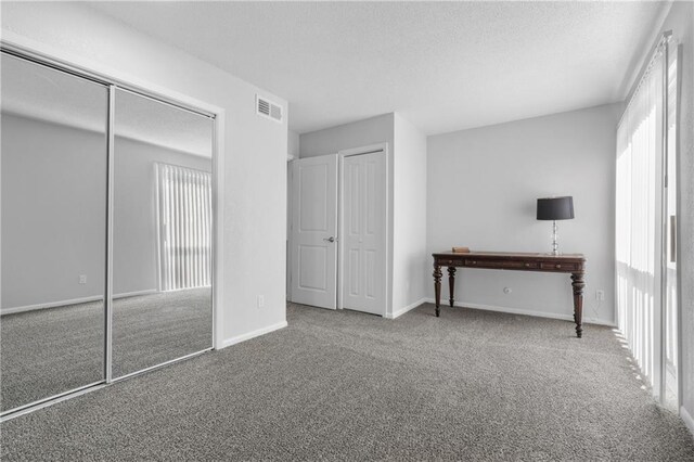 unfurnished bedroom with carpet floors