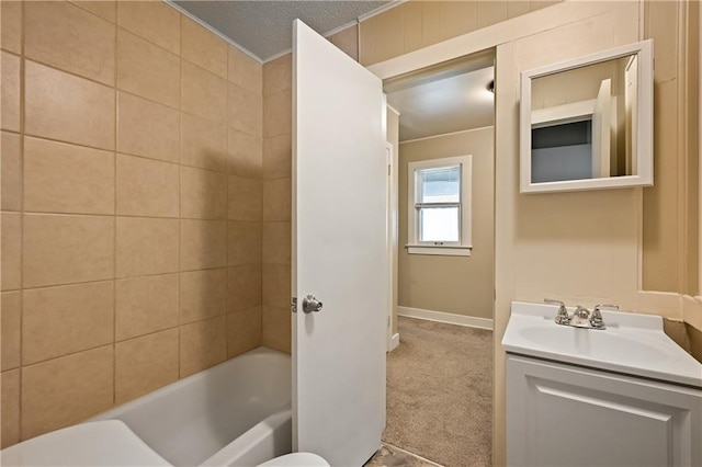 full bathroom featuring toilet, tiled shower / bath, vanity, and a textured ceiling