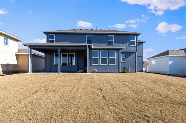 rear view of house with central AC unit, a yard, and a patio area