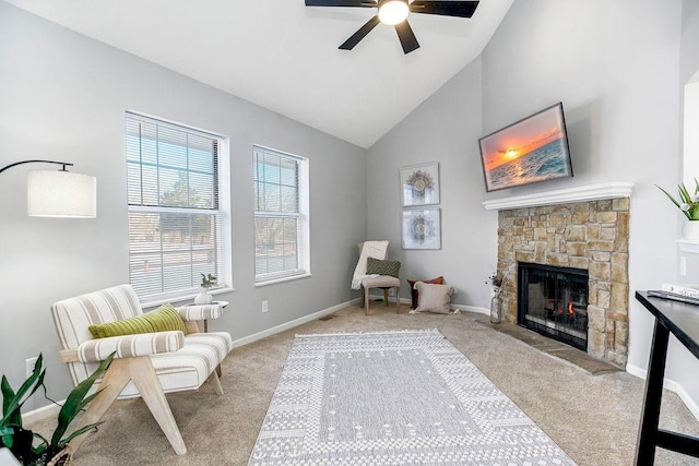 sitting room featuring ceiling fan, light colored carpet, a stone fireplace, and high vaulted ceiling