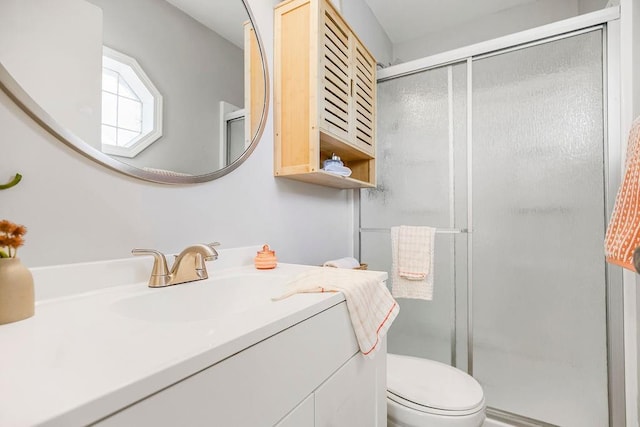 bathroom featuring toilet, vanity, and an enclosed shower