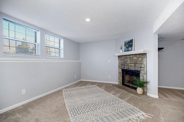 living room featuring a textured ceiling, light carpet, and a fireplace