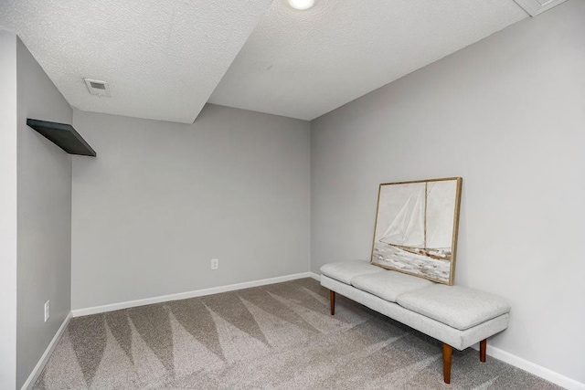 unfurnished room featuring carpet floors and a textured ceiling