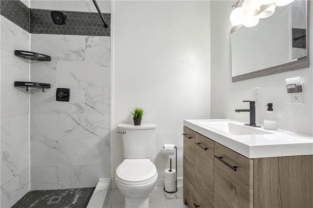 bathroom featuring vanity, toilet, and a tile shower