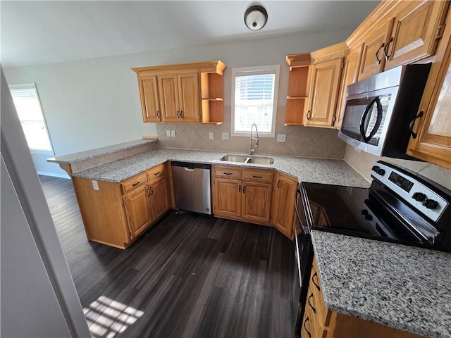 kitchen featuring dark wood-type flooring, a sink, open shelves, stainless steel appliances, and a peninsula