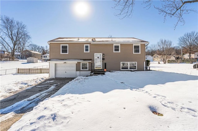 snow covered property featuring a garage