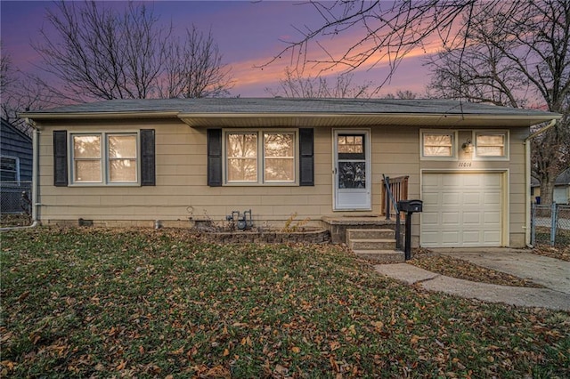 single story home with a garage and a yard