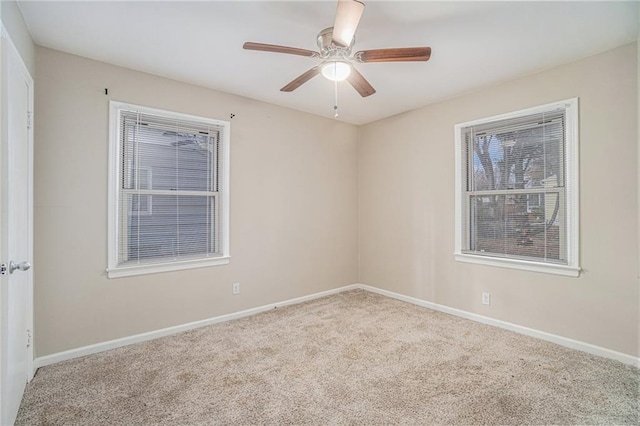 carpeted spare room with ceiling fan