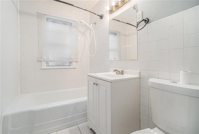 full bathroom with toilet, vanity, tile patterned flooring, tile walls, and tiled shower / bath combo