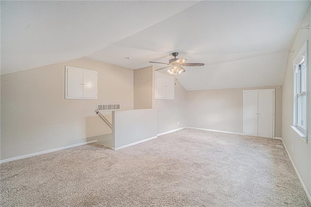 bonus room featuring ceiling fan, carpet, and lofted ceiling