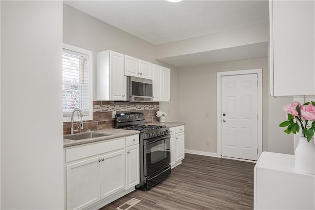 kitchen featuring sink, white cabinetry, and black range with gas cooktop