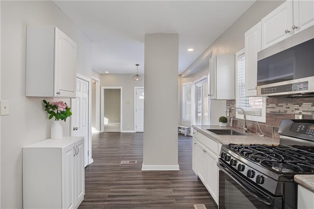 kitchen featuring white cabinetry, tasteful backsplash, sink, black gas stove, and dark hardwood / wood-style floors