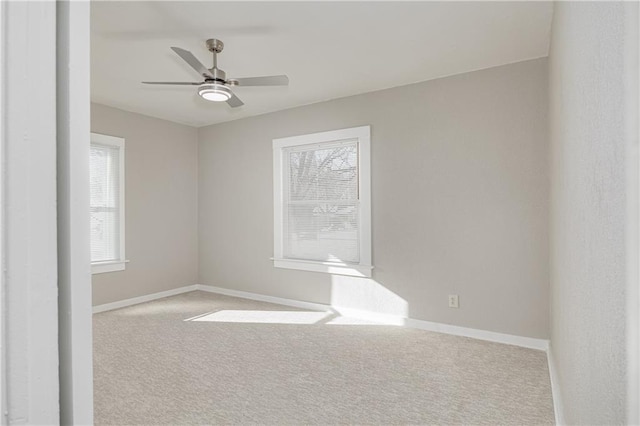 unfurnished room featuring ceiling fan and light colored carpet