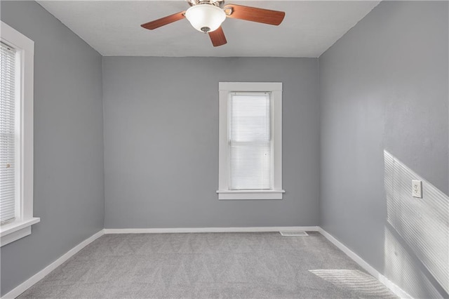 unfurnished room with ceiling fan and light colored carpet