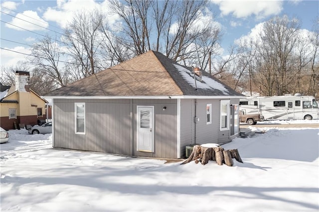 view of snow covered rear of property