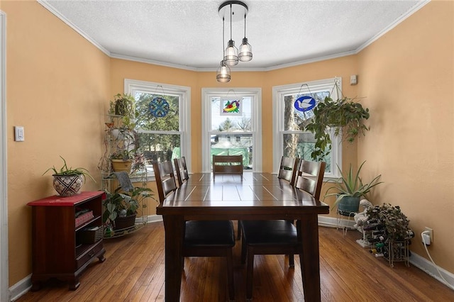 dining space featuring wood-type flooring and crown molding