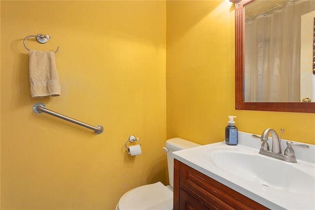 bathroom featuring toilet and vanity