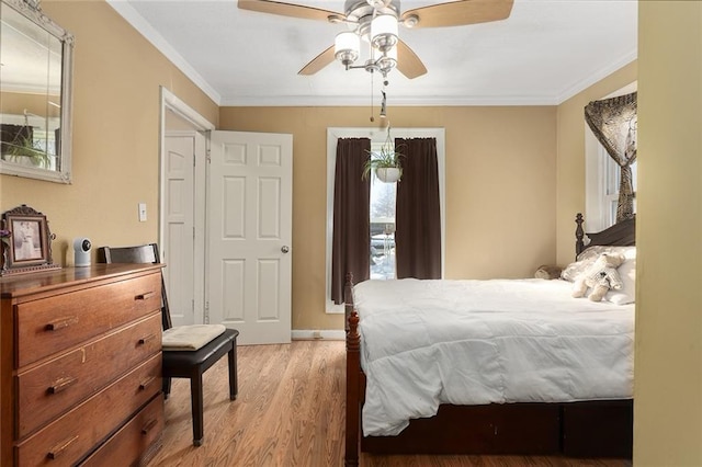 bedroom with ceiling fan, crown molding, and light hardwood / wood-style flooring