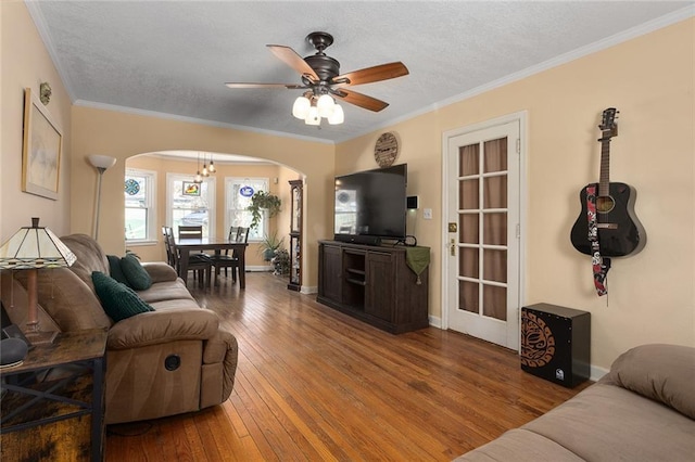 living room featuring ceiling fan, crown molding, a textured ceiling, and hardwood / wood-style flooring