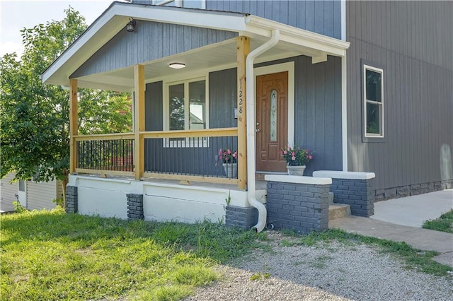 view of exterior entry with a porch