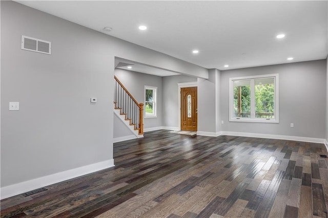 unfurnished living room with dark hardwood / wood-style flooring