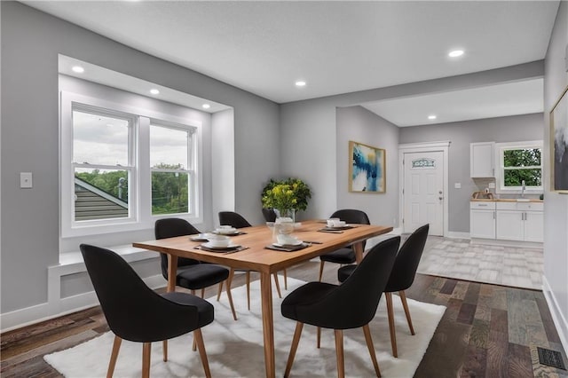 dining space with dark hardwood / wood-style floors