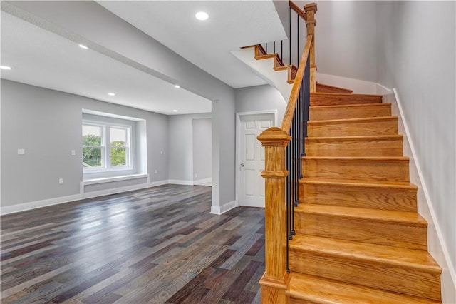 stairs featuring hardwood / wood-style floors