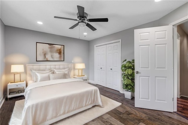 bedroom with a closet, ceiling fan, and dark hardwood / wood-style flooring