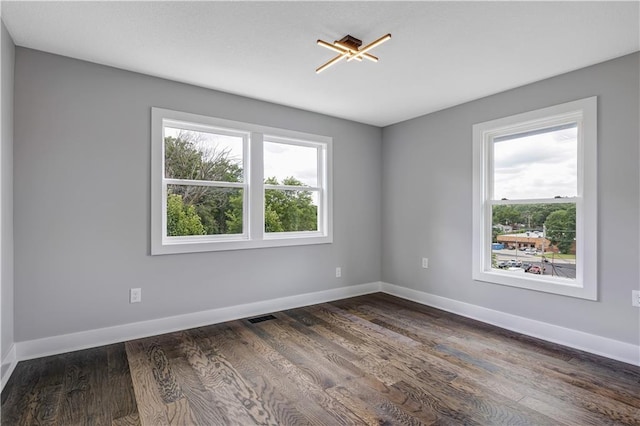 unfurnished room featuring dark hardwood / wood-style flooring