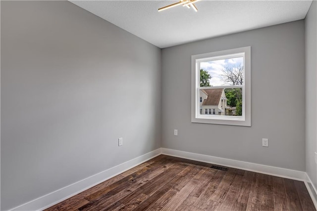 empty room featuring dark wood-type flooring